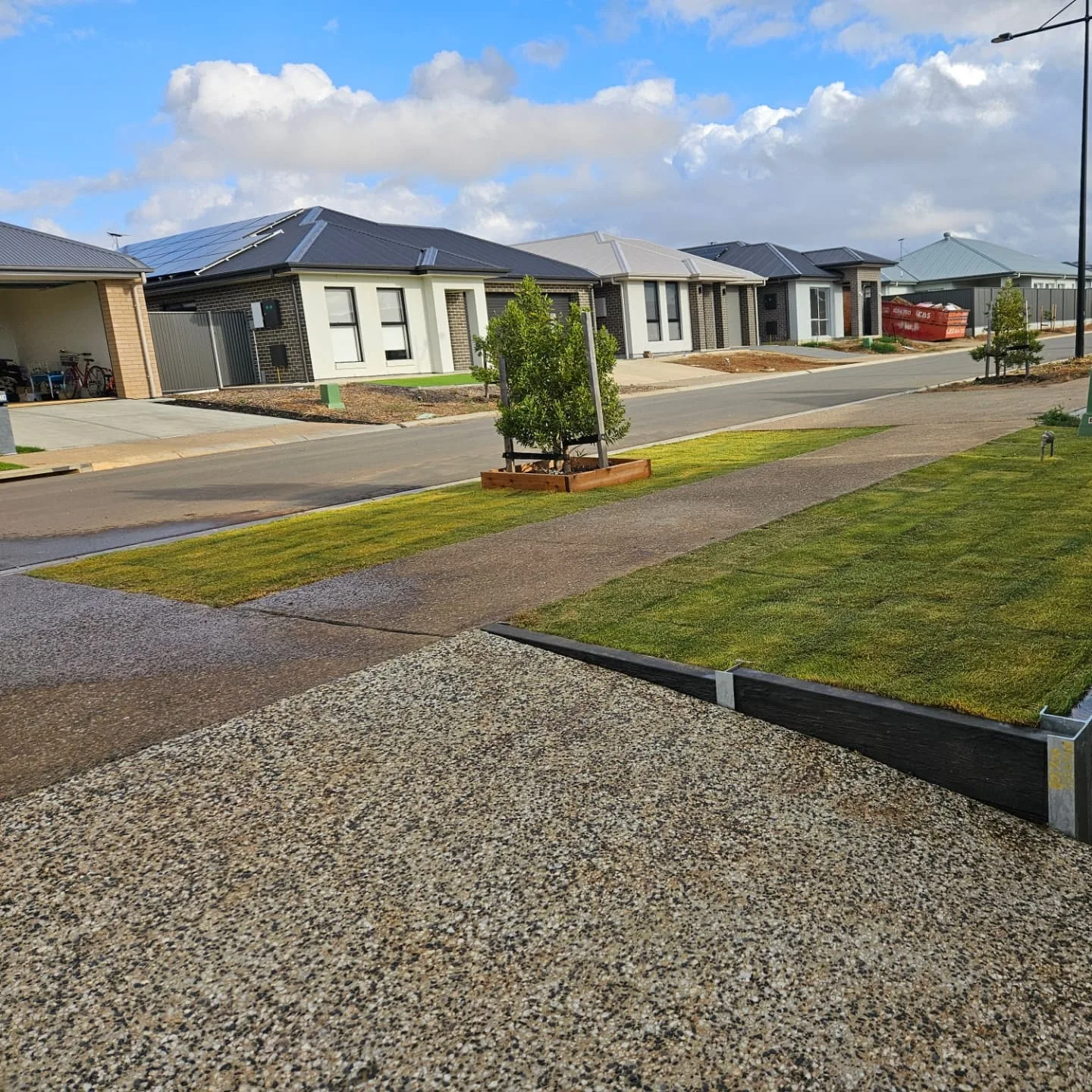 Front yard lawn with a gravel verge on a new estate street