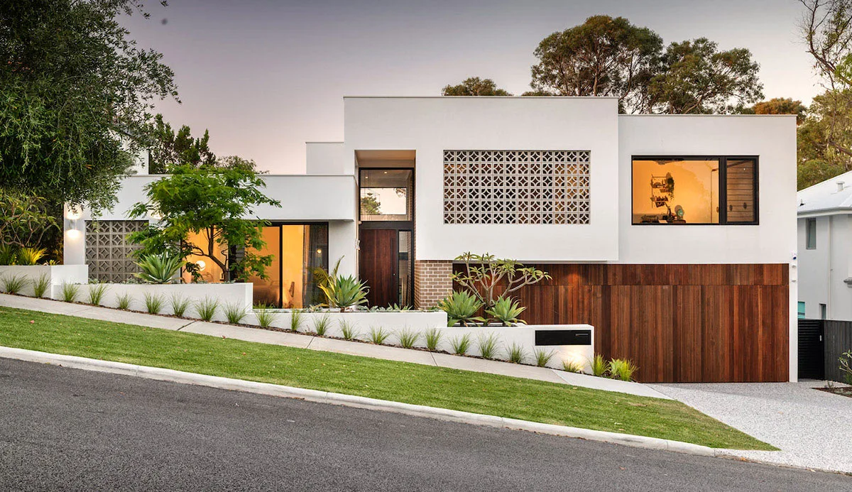 Modern home with a newly planted front garden and sloping lawn